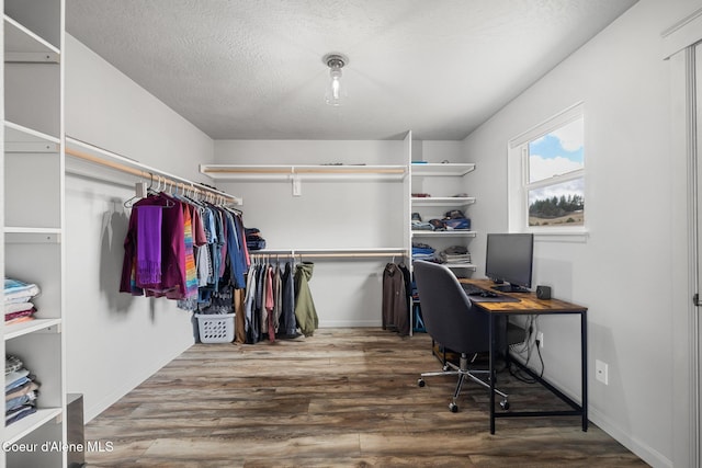 office space with baseboards, a textured ceiling, and wood finished floors