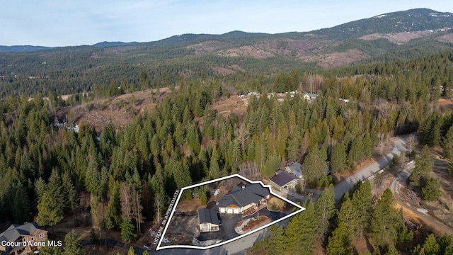 aerial view with a mountain view and a wooded view