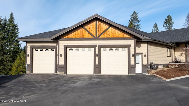 view of front of home featuring aphalt driveway and an attached garage