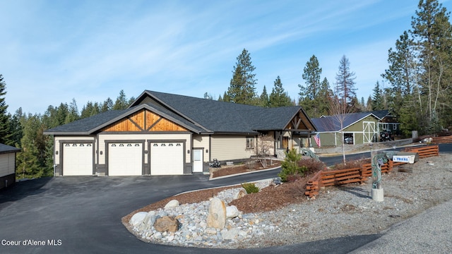 view of front of house featuring a garage and aphalt driveway