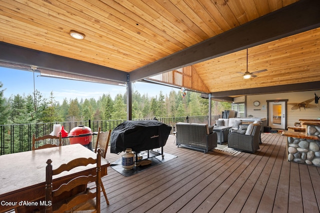 wooden deck with an outdoor living space, a grill, and a ceiling fan