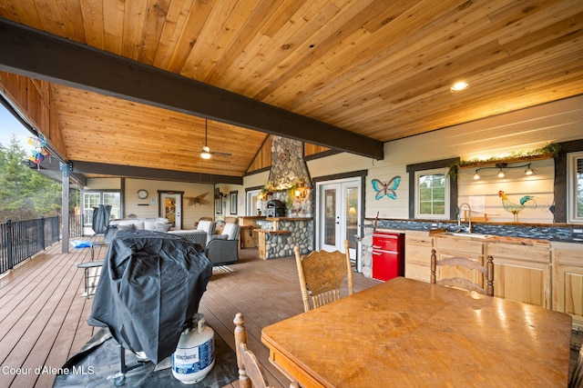 dining space with lofted ceiling with beams, wood-type flooring, and wooden ceiling