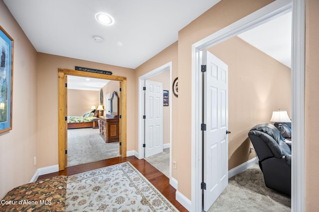 hall with wood finished floors and baseboards