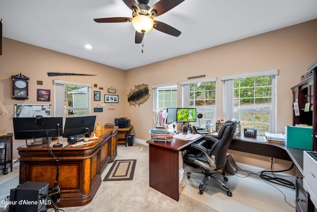 office with baseboards, plenty of natural light, light colored carpet, and ceiling fan