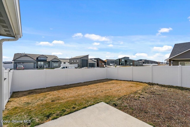 view of yard with a fenced backyard and a residential view