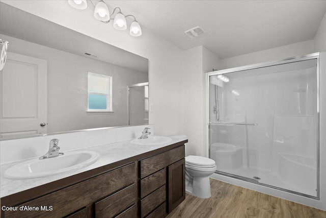 full bath featuring visible vents, a shower stall, and a sink