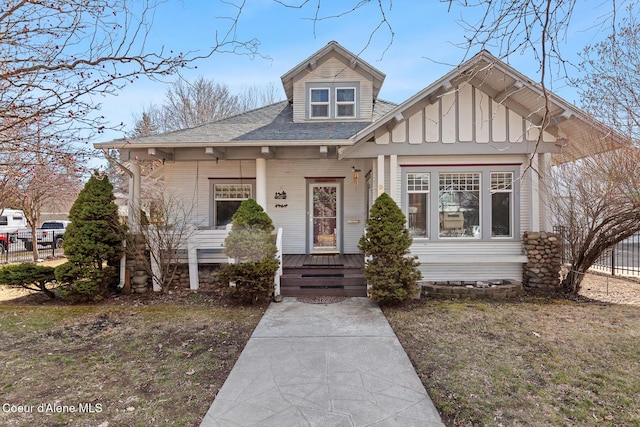 view of front of house with fence and board and batten siding