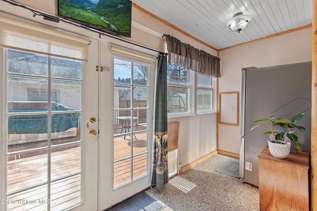 entryway featuring french doors, crown molding, and baseboards