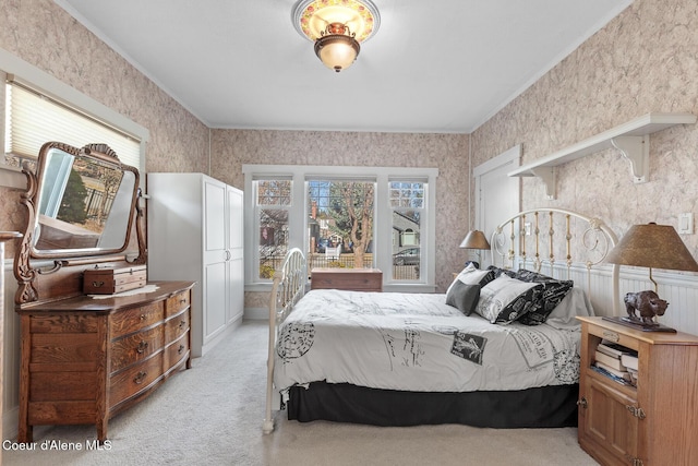 bedroom featuring wallpapered walls, light carpet, and ornamental molding