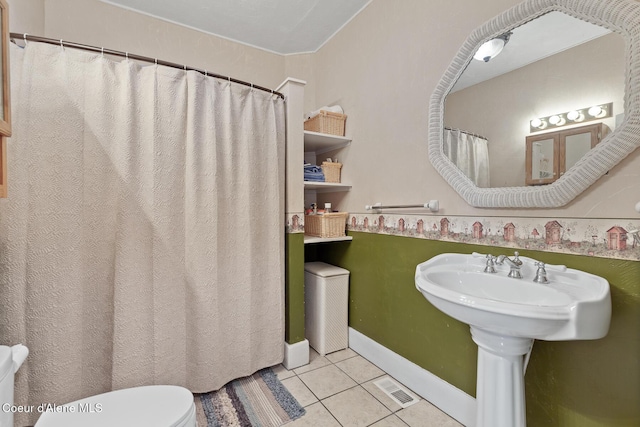 bathroom with visible vents, baseboards, toilet, and tile patterned flooring