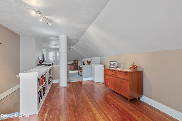 bonus room featuring baseboards, lofted ceiling, and hardwood / wood-style floors