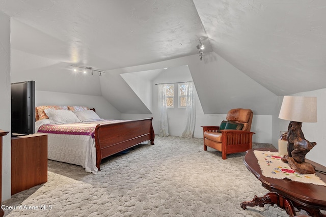 carpeted bedroom featuring vaulted ceiling