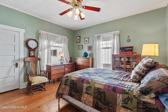 924 E Front Ave, Coeur Dalene, ID 83814 - bedroom with wood finished floors, crown molding, and ceiling fan