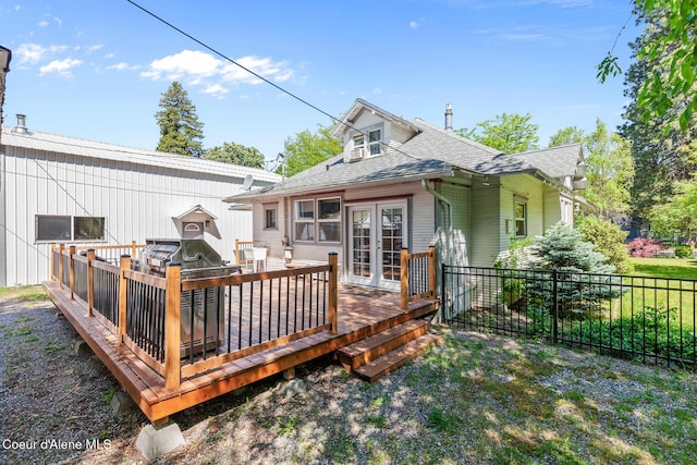924 E Front Ave, Coeur Dalene, ID 83814 - back of property featuring french doors, a shingled roof, and a wooden deck