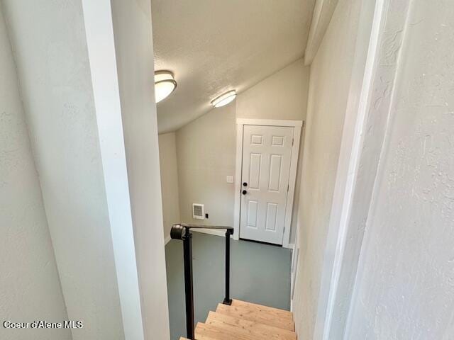 stairs featuring visible vents and vaulted ceiling