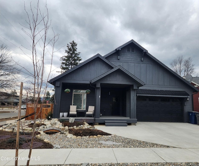 view of front facade with covered porch, board and batten siding, concrete driveway, and a garage