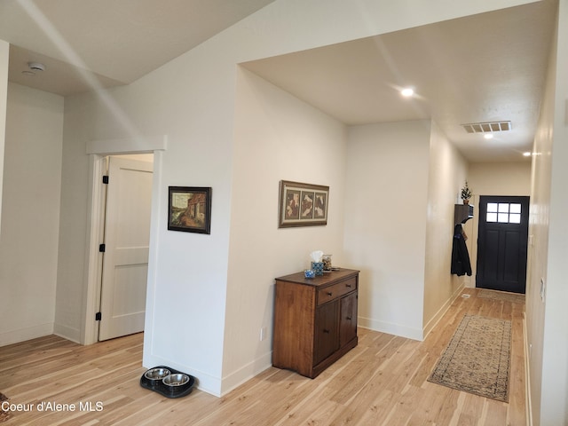 entryway with visible vents, light wood-style flooring, and baseboards