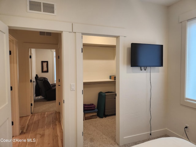 interior space with wood finished floors and visible vents