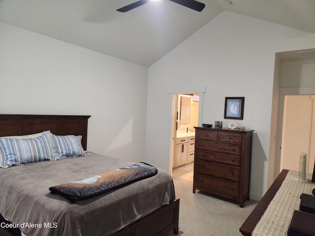 bedroom featuring visible vents, light carpet, high vaulted ceiling, ensuite bath, and ceiling fan