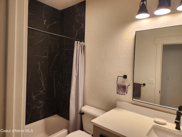 bathroom featuring toilet, vanity, shower / bath combo with shower curtain, and a textured wall