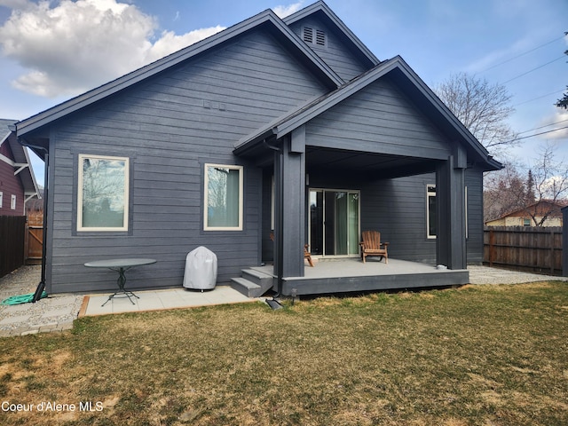 back of property featuring a deck, a yard, and fence