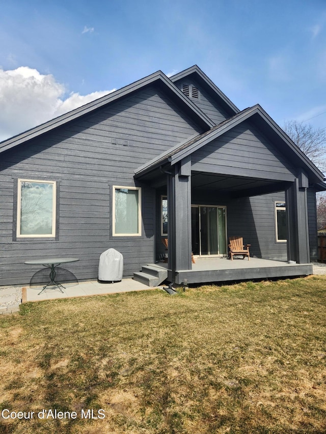 back of house with a yard, a patio, and a deck