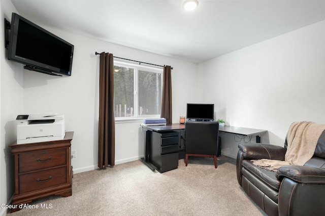 office space featuring baseboards and light colored carpet