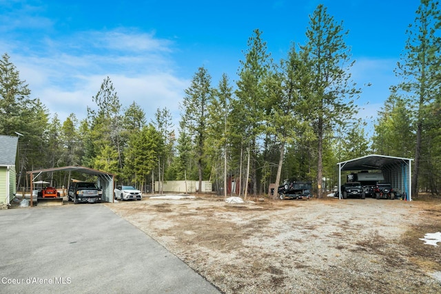 view of yard with a carport and driveway