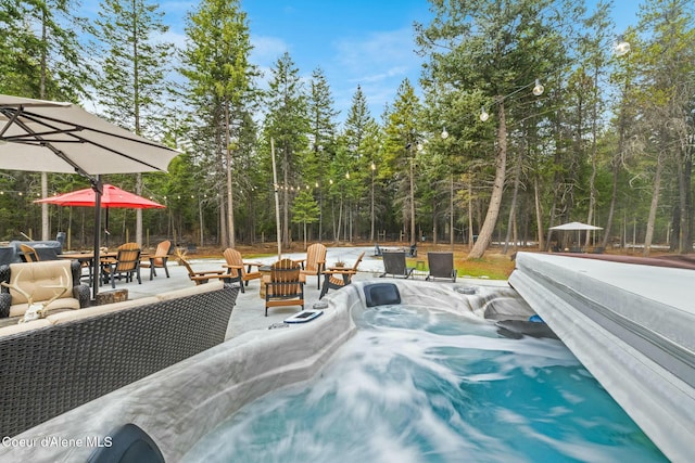 view of swimming pool with a patio area, an outdoor living space, and a hot tub