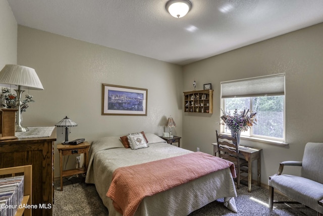 bedroom with a textured wall, baseboards, and carpet floors