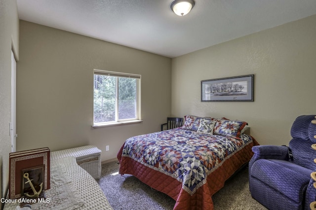 bedroom with baseboards and carpet