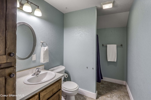 full bathroom with a shower with curtain, toilet, baseboards, vanity, and a textured wall