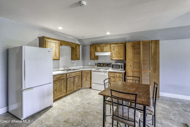 kitchen with baseboards, under cabinet range hood, brown cabinets, white appliances, and a sink