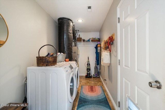 laundry area featuring laundry area, visible vents, and separate washer and dryer