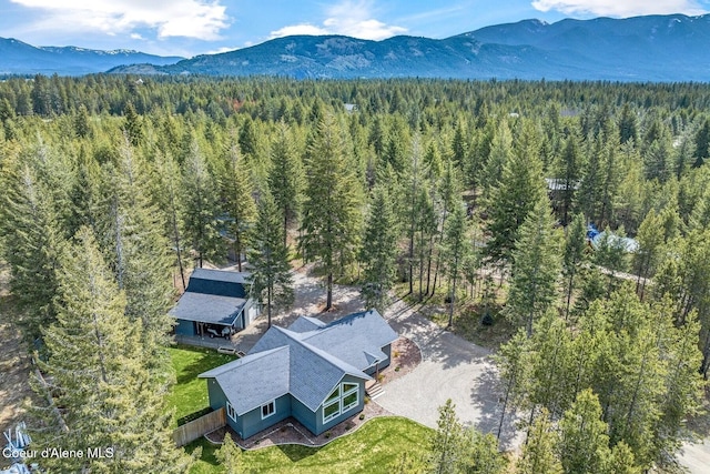 drone / aerial view with a mountain view and a wooded view