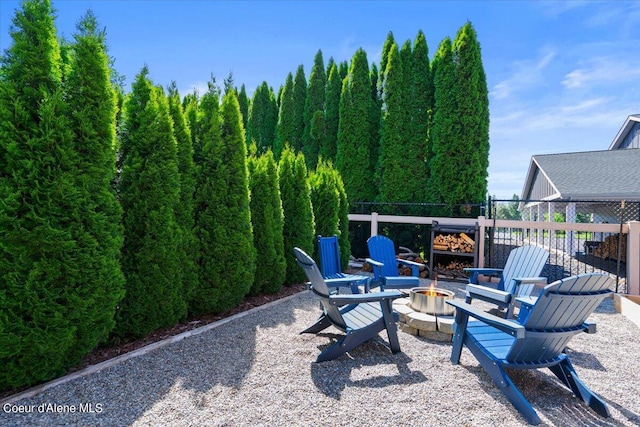 view of patio with fence and an outdoor fire pit