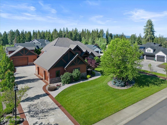 view of front of home with a garage, an outdoor structure, a front lawn, and stone siding