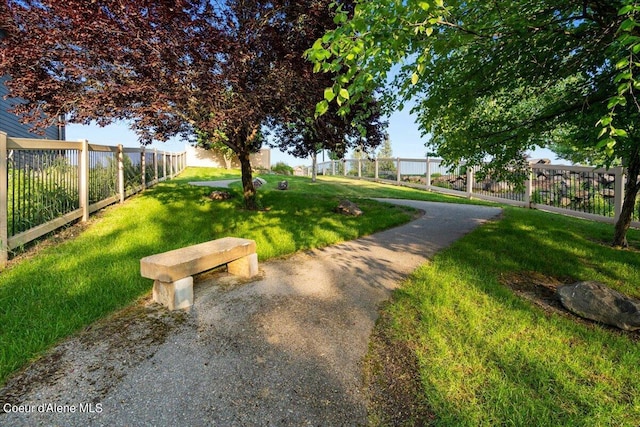 view of home's community with a yard and a fenced backyard