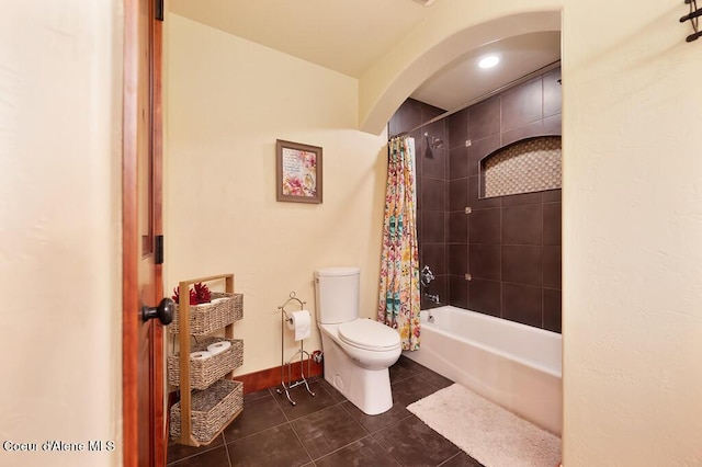 full bath with tile patterned flooring, toilet, baseboards, and shower / bath combo