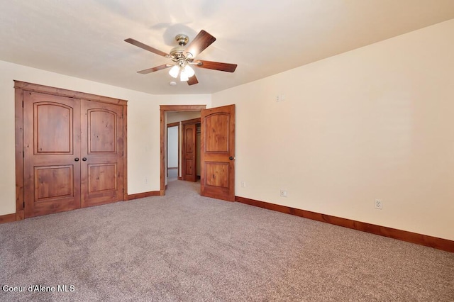 unfurnished bedroom with baseboards, light carpet, and a ceiling fan