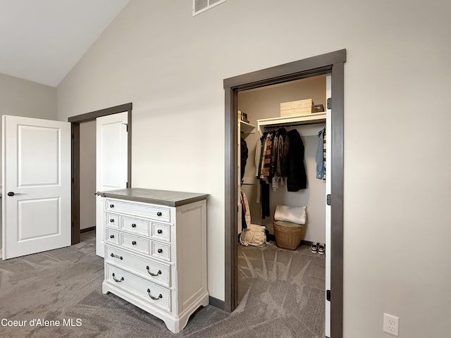 bedroom with visible vents, carpet, a spacious closet, and vaulted ceiling