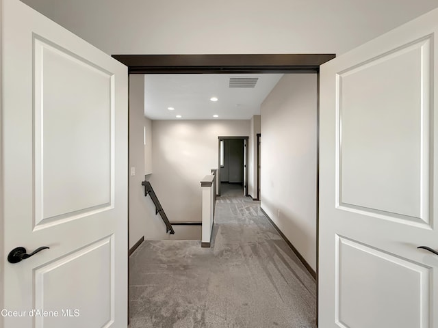 corridor featuring visible vents, recessed lighting, an upstairs landing, and light colored carpet