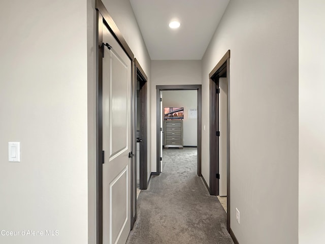 corridor with light carpet and baseboards