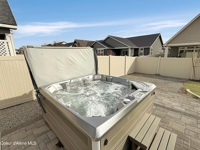 deck featuring a fenced backyard and a hot tub