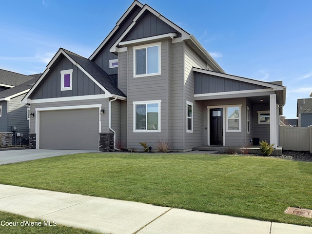 craftsman inspired home featuring a front lawn, a garage, board and batten siding, and concrete driveway