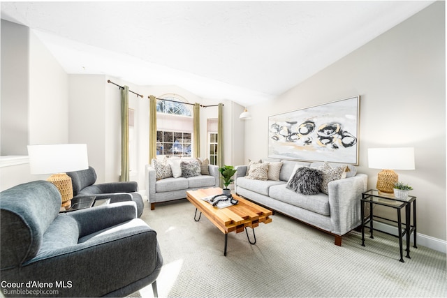 living room featuring carpet floors, baseboards, and vaulted ceiling