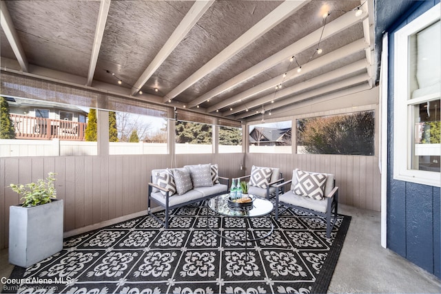 sunroom / solarium with lofted ceiling with beams