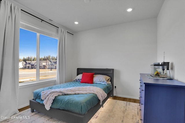 bedroom with recessed lighting, baseboards, and wood finished floors