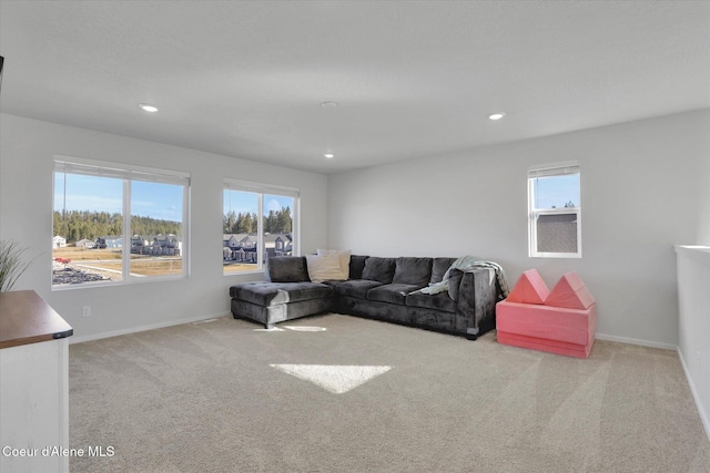 carpeted living area featuring a wealth of natural light, baseboards, and recessed lighting