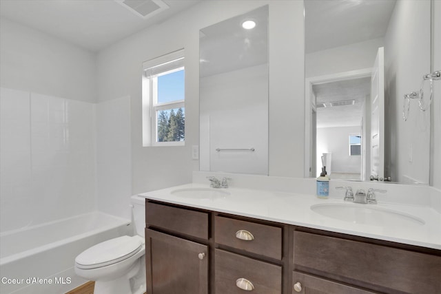 full bath with double vanity, toilet, visible vents, and a sink